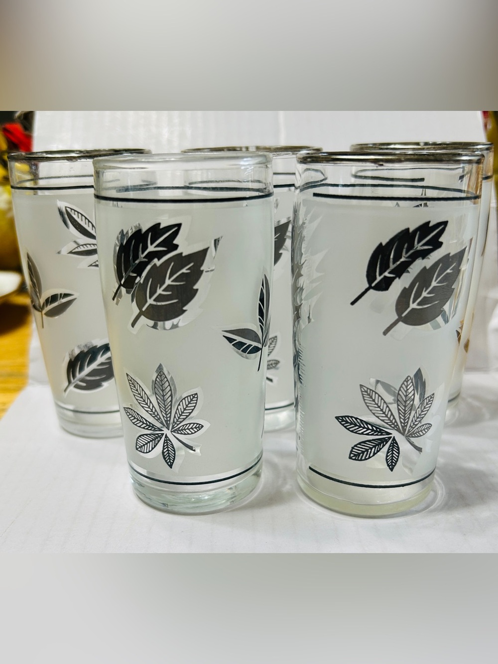Vintage juice glasses by Libbey in silver leaf frosted pattern with silver rim.